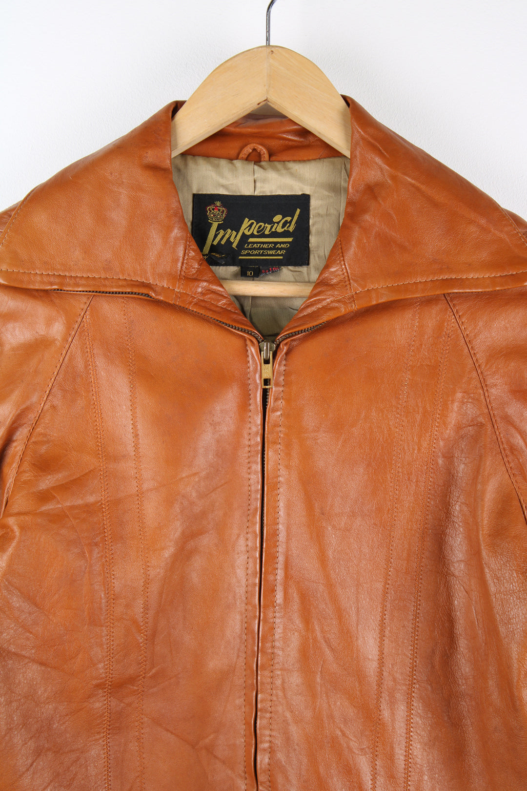 Vintage 1970's orange/tan zip through leather jacket, by Imperial. Features dagger collar, and drawstring waist 