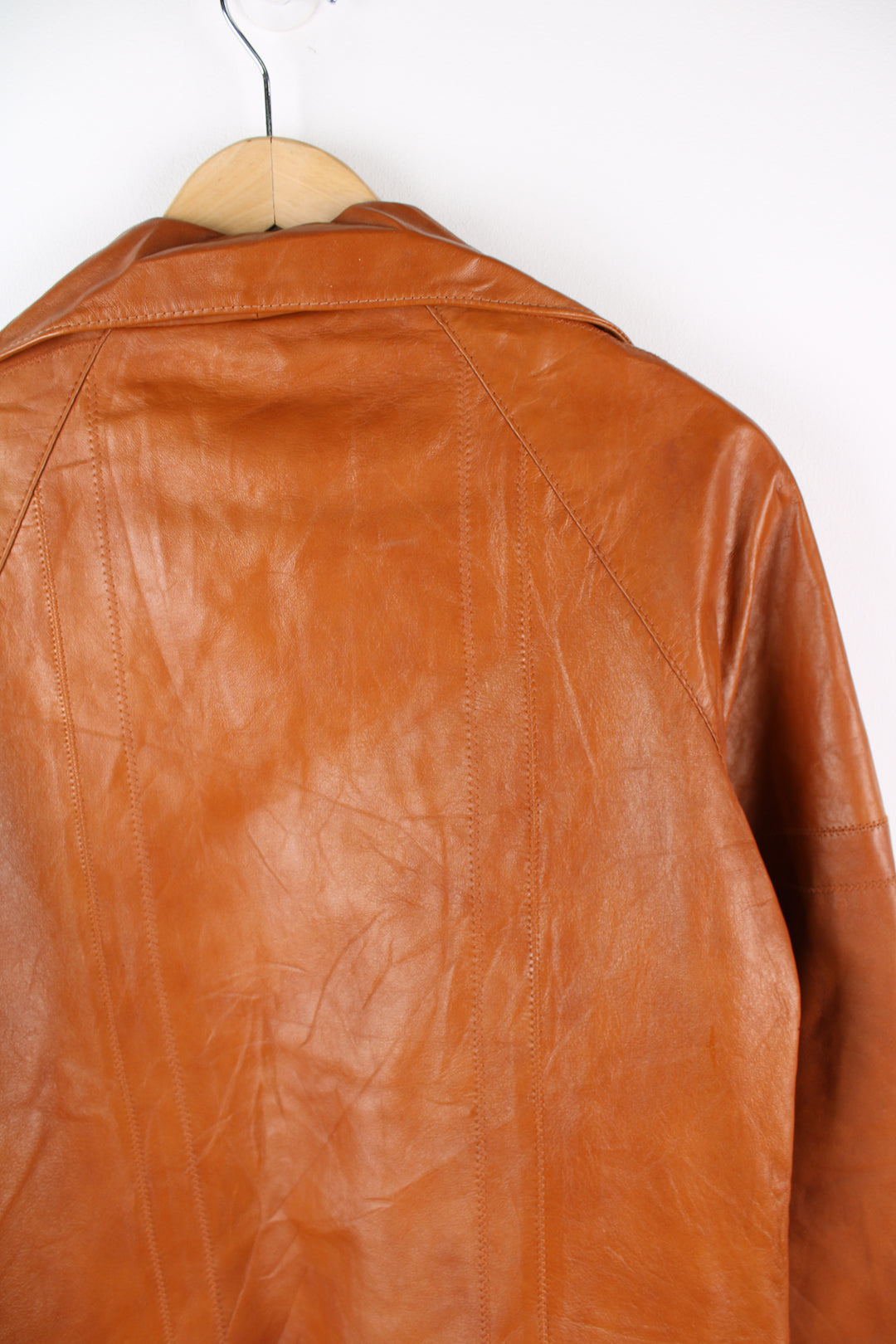 Vintage 1970's orange/tan zip through leather jacket, by Imperial. Features dagger collar, and drawstring waist 