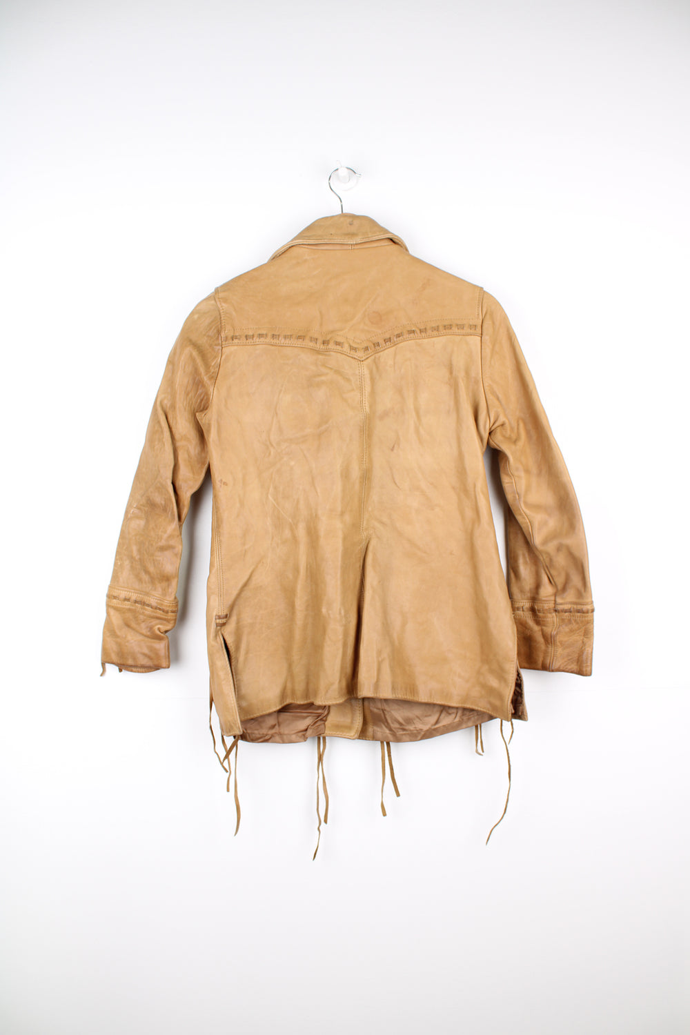 Vintage made in Albuquerque smooth tan leather jacket with fringe details on the pockets, raised stitched detailing on the sleeves and pockets and leather toggle buttons 