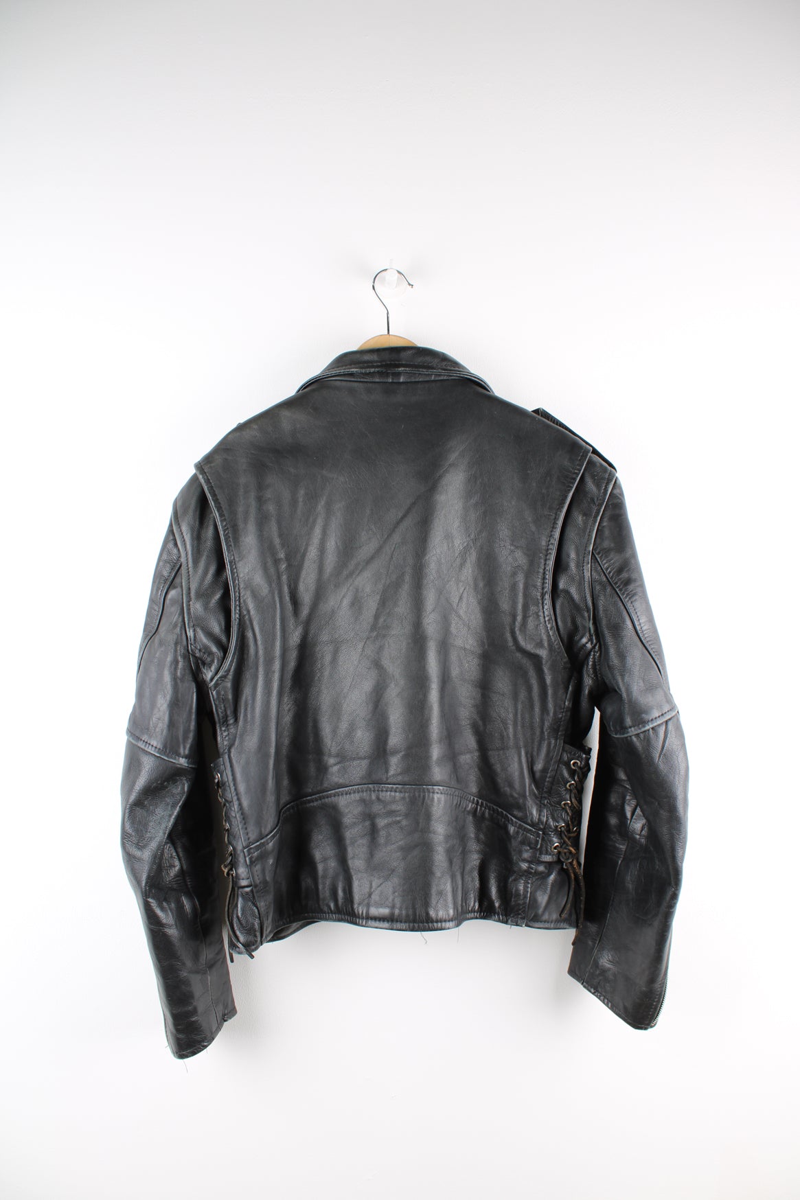 Vintage First biker jacket made from 100% genuine leather, features multiple zip up pockets, lace up details on the hips and chunky belt