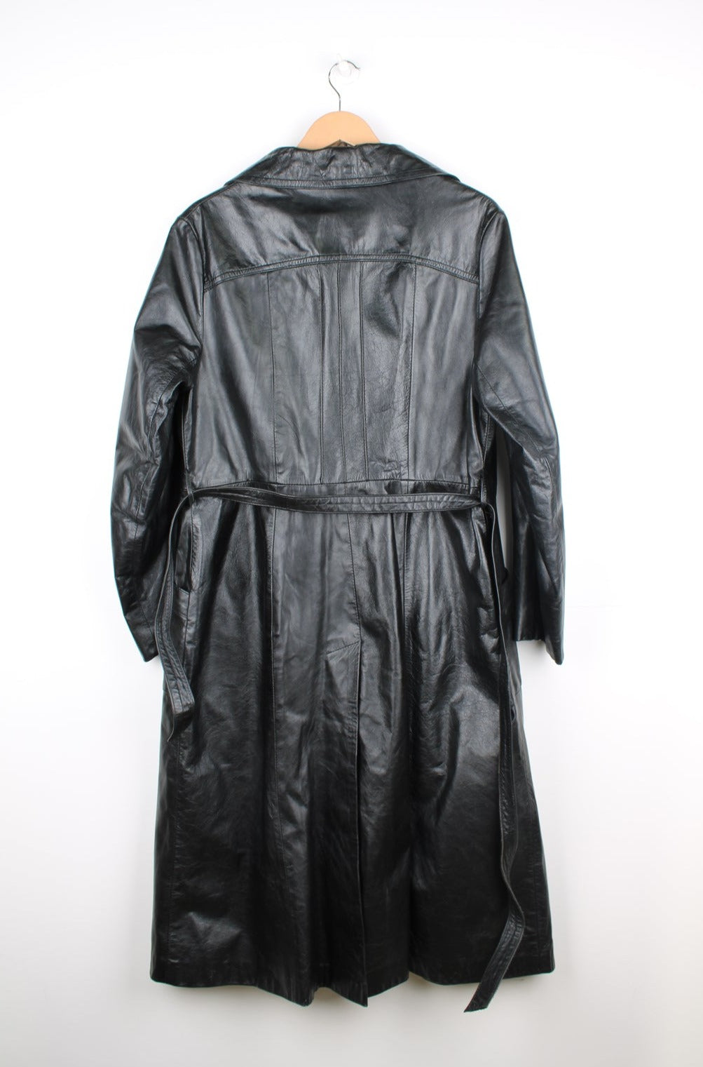 Vintage all black leather trench coat with belt, closes with buttons down the front and has pleated details on the chest  