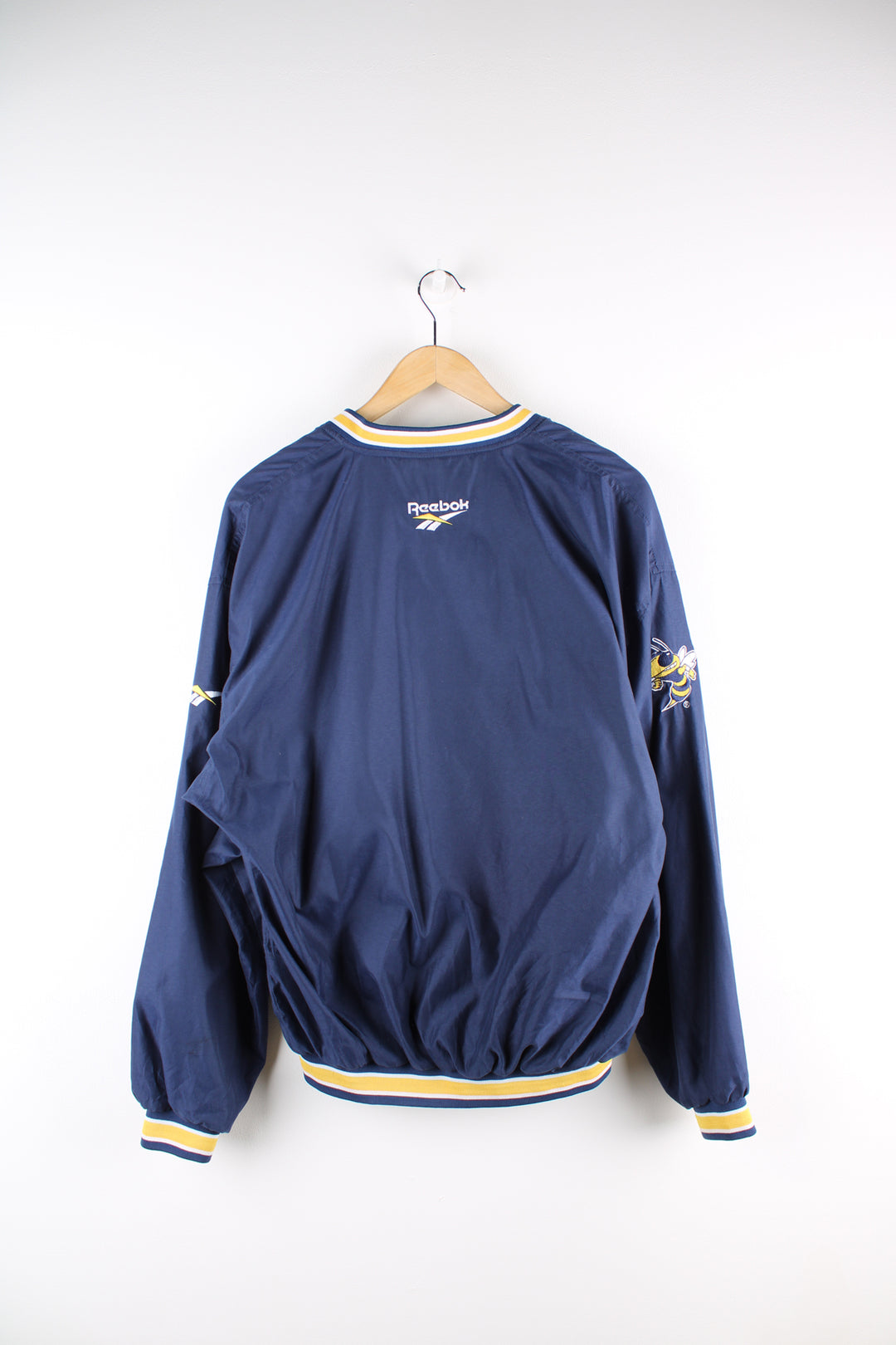 Vintage Reebok, Georgia Tech University sports drill top, blue and yellow team colourway, v neck, side pockets, embroidered logos on the front and back.