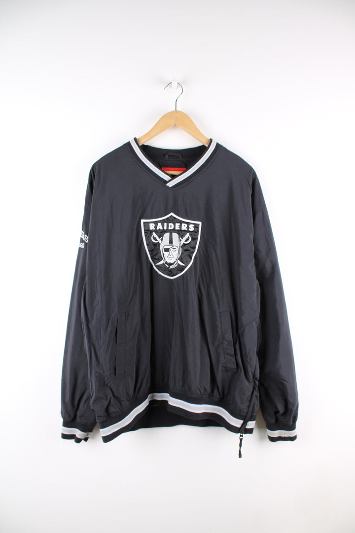 Vintage NFL Oakland Raiders drill top in black and grey team colourway, v neck, side pockets, and has logo embroidered on the front.