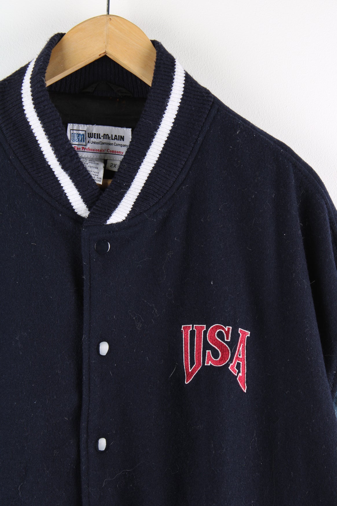 Vintage USA workwear varsity jacket in blue, woollen with denim sleeves, button up, pockets either side and USA embroidered on the front. 