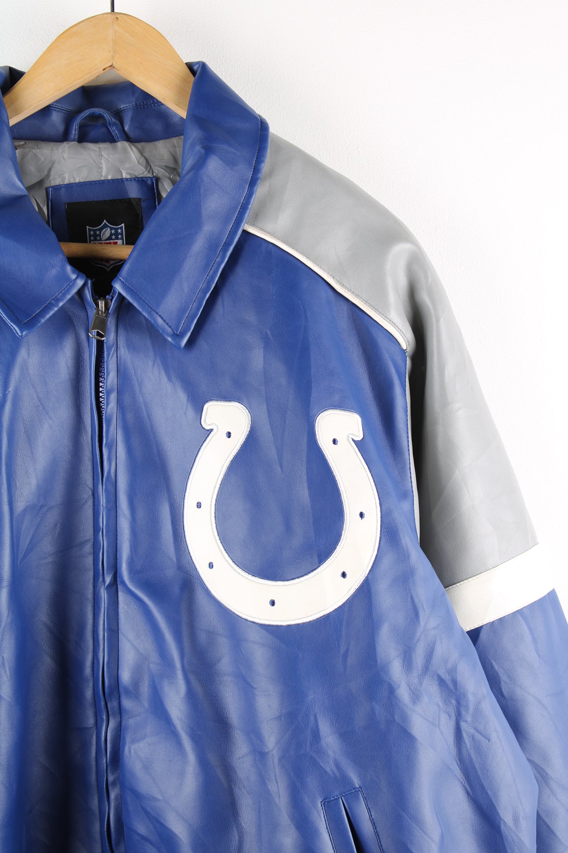 Vintage NFL Indianapolis Colts NFL varsity jacket in a blue, grey and white colourway, zip up with side pockets, quilted lining and has embroidered logos on the front and back. 