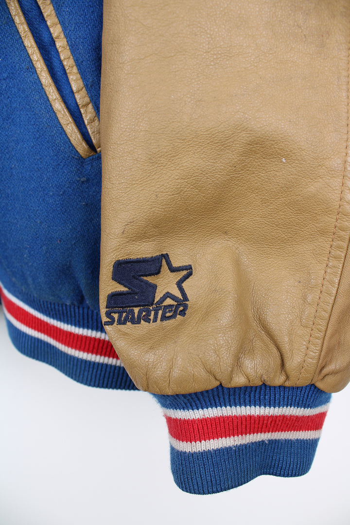 90's New York Giants varsity jacket with blue wool body and tan leather arms. Features embroidered logos on the arms and felt applique logo across the chest  good condition - Discoloration around the collar and scuffs to the leather on the arms and bobbling through out (see photos) Size in Label: Mens XL 