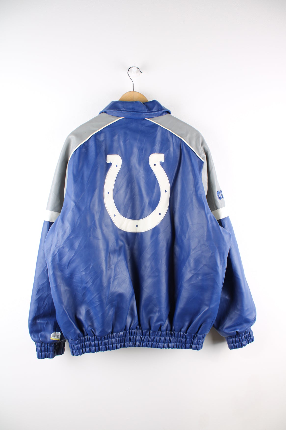 Vintage NFL Indianapolis Colts NFL varsity jacket in a blue, grey and white colourway, zip up with side pockets, quilted lining and has embroidered logos on the front and back. 