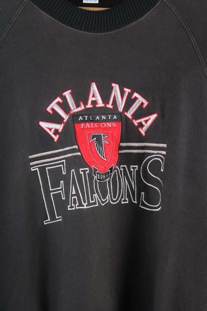 Vintage NFL Atlanta Falcons sweatshirt in black, grey and red team colourway, crewneck with embroidered spell out and logo across the front. 