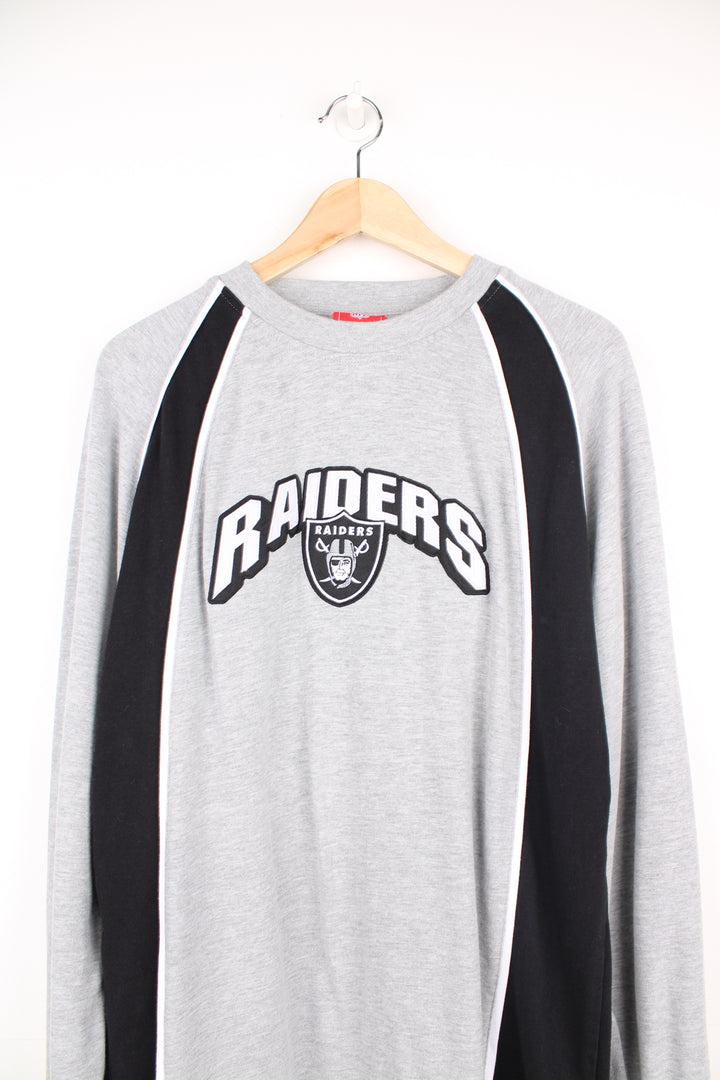 Oakland (now Las Vegas) Raiders grey long sleeve t-shirt made by NFL. Features embroidered logo on the front good condition - Faint mark on the front side (see photos) Size in Label:  Mens L