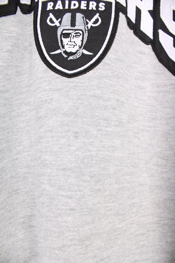 Oakland (now Las Vegas) Raiders grey long sleeve t-shirt made by NFL. Features embroidered logo on the front good condition - Faint mark on the front side (see photos) Size in Label:  Mens L