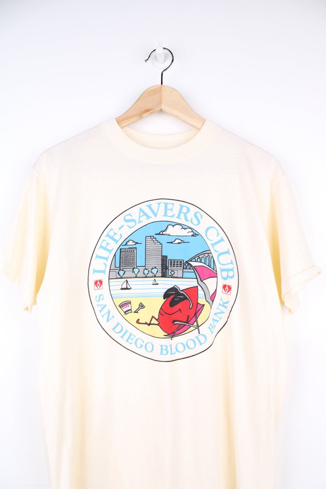 Vintage San Diego Blood Bank, Cartoon Graphic T-Shirt in a tan colourway with graphic design printed on the front, Hanes fifty fifty label and is single stitch.