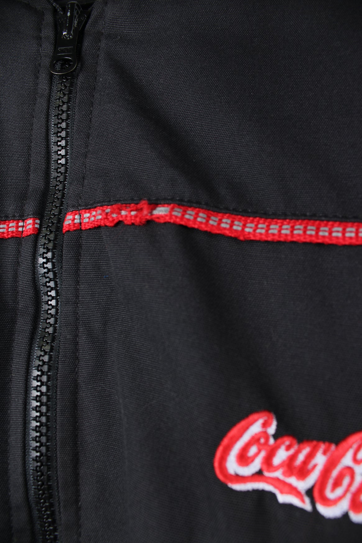 Coca Cola employee black zip through bomber jacket, features embroidered logo on the chest and back of shoulders