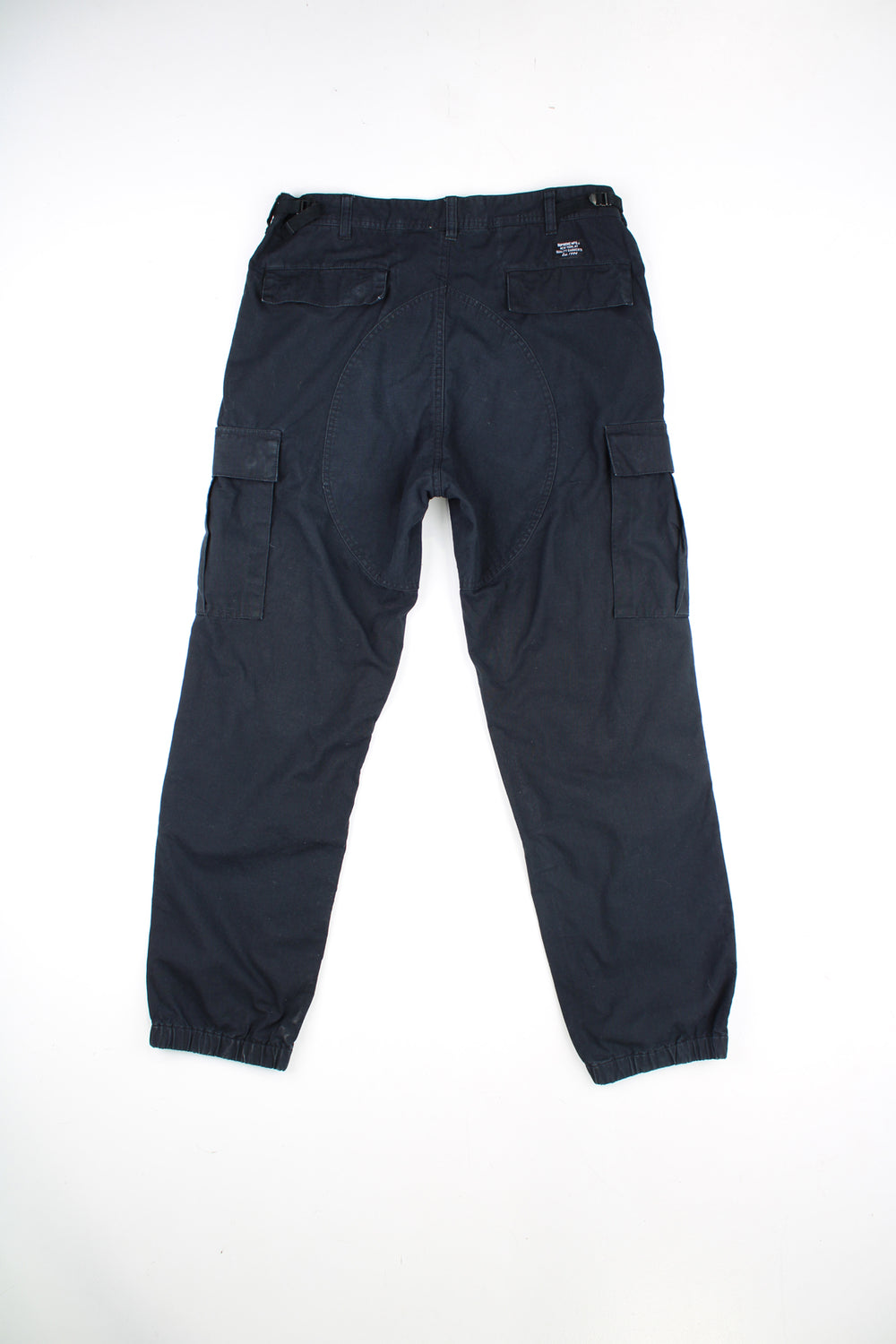 Supreme all black cargo trousers with adjustable straps on the waistband and multiple pockets