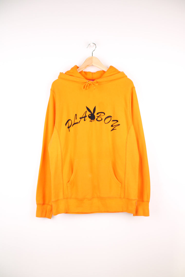 Supreme x Playboy 100% cotton hoodie in orange, made in Canada. Features embroidered spell-out logo across the chest