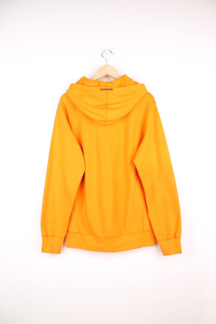 Supreme x Playboy 100% cotton hoodie in orange, made in Canada. Features embroidered spell-out logo across the chest