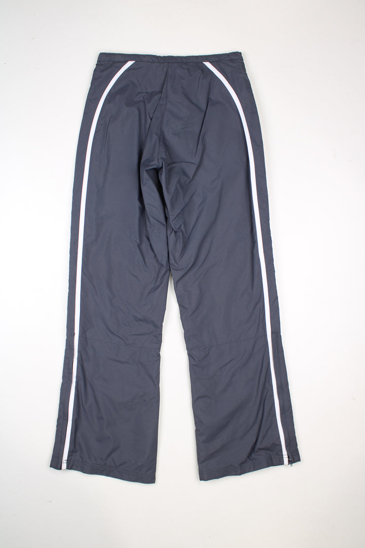 Vintage Reebok tracksuit bottoms in grey with pink and white stripes going down the sides, and embroidered logo on the front.