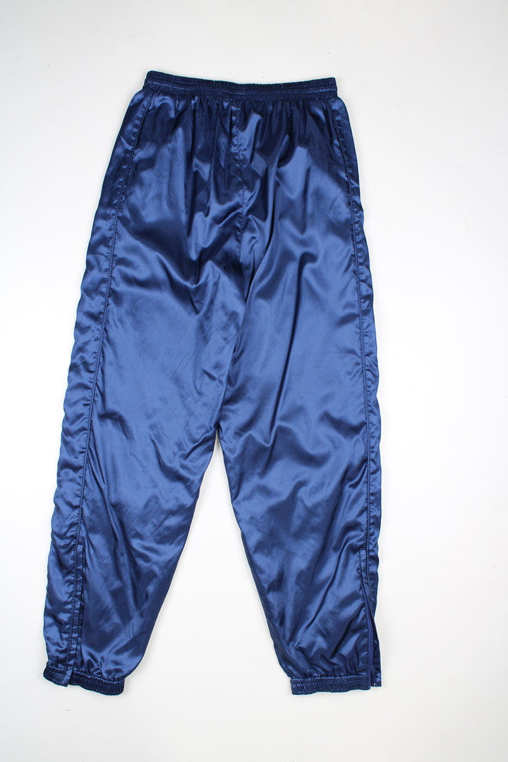 Vintage Puma System tracksuit bottoms in a blue colourway, elasticated waist and cuffed at the bottom, has logo embroidered on the front.