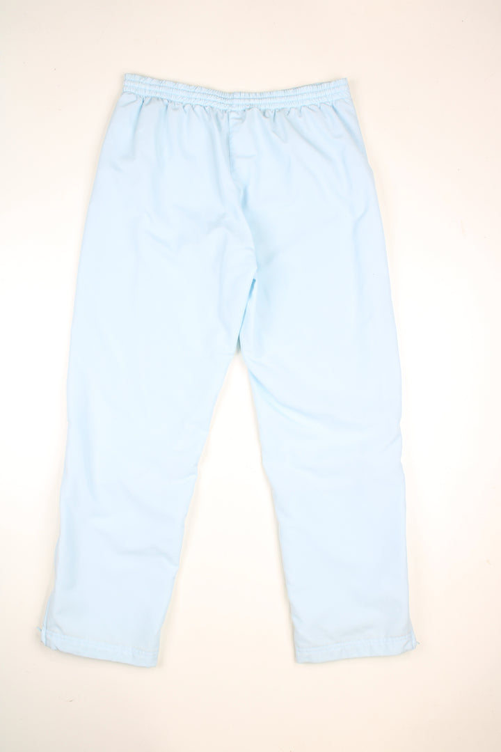 Vintage Adidas tracksuit bottoms in a baby blue colourway, elasticated waist, pockets and has logo embroidered on the front.