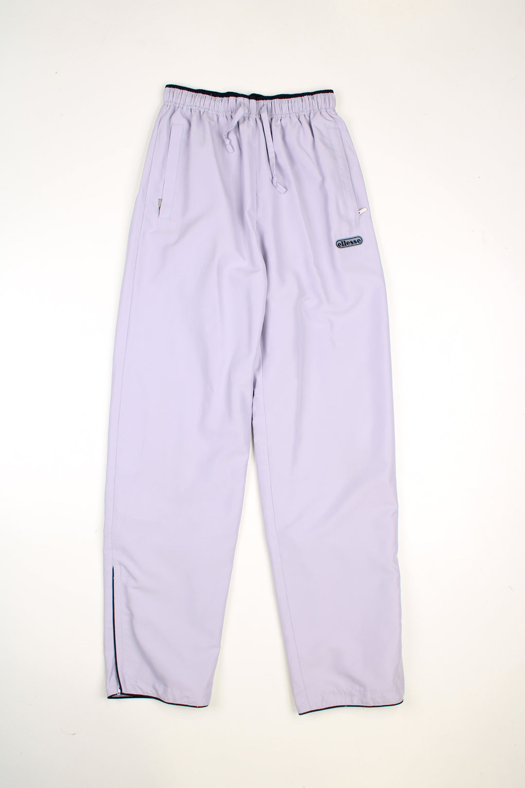 Vintage Ellesse tracksuit bottoms in a purple colourway, elasticated waist, pockets and has logo embroidered on the front.