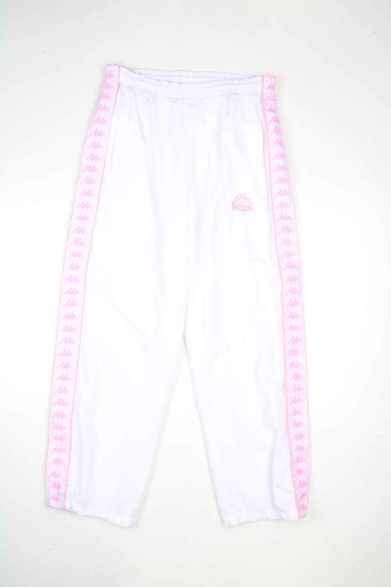 Vintage Kappa tracksuit bottoms in a white colourway with pink logo going down the sides, elasticated waist, and has logo embroidered on the front.