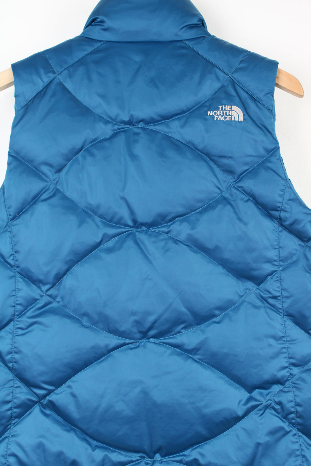 The North Face 550 bright blue double pocket satin gilet with embroidered logo on the front & back