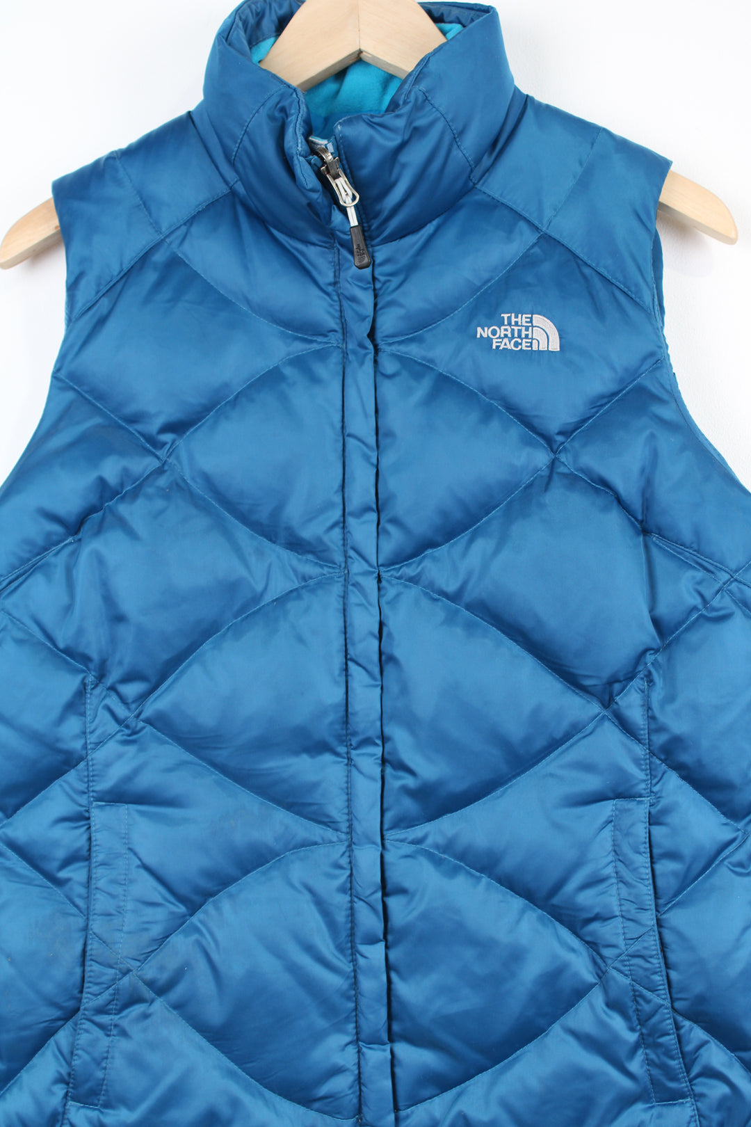 The North Face 550 bright blue double pocket satin gilet with embroidered logo on the front & back