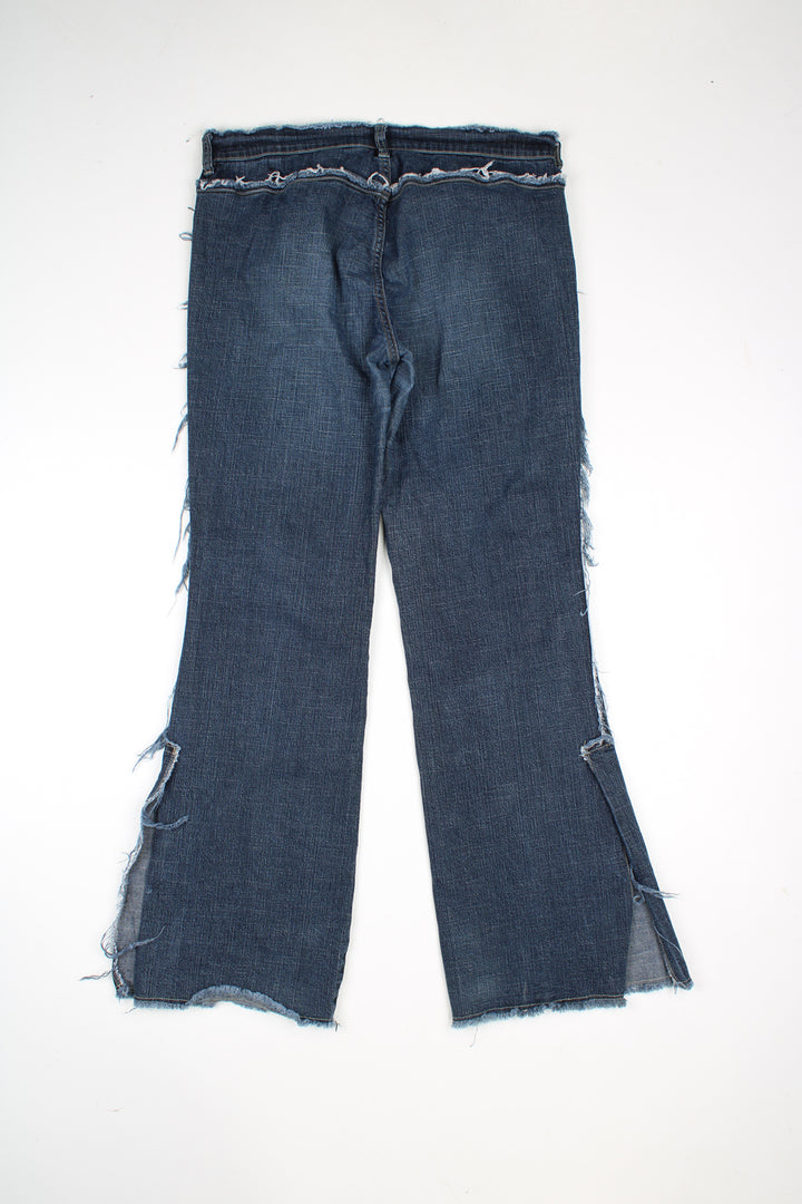 Diesel low rise bootcut jeans with distressed hem detail.  good condition  Size in Label:  31 (L)