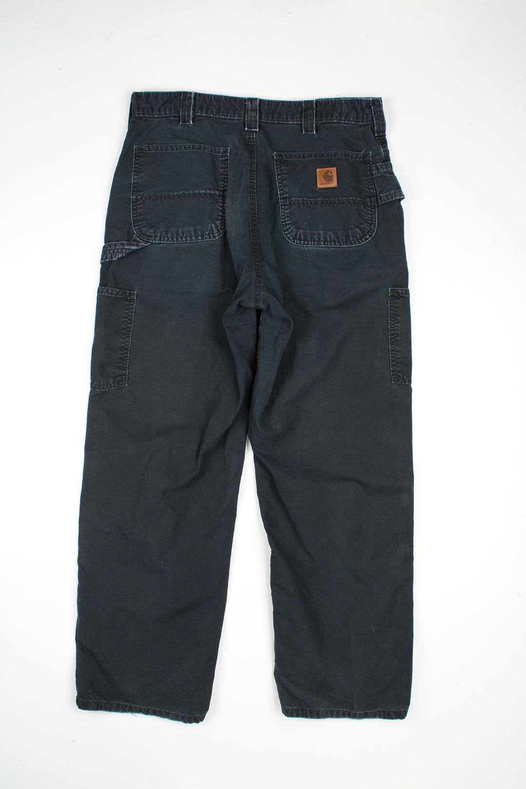 Black Carhartt 100% cotton carpenter trousers with multiple pockets and signature brown leather logo on the back pocket