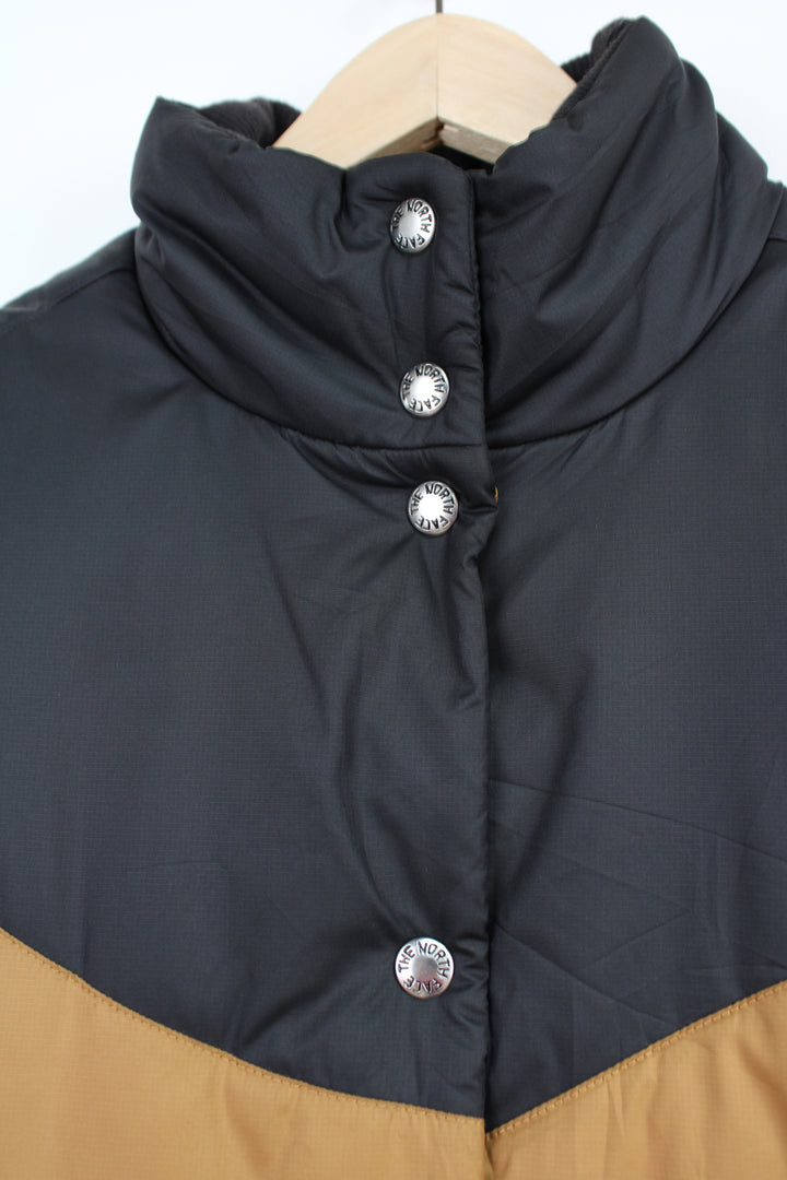 The North Face 'Sylvester' brown and black button up puffer gilet with embroidered logo on the hem