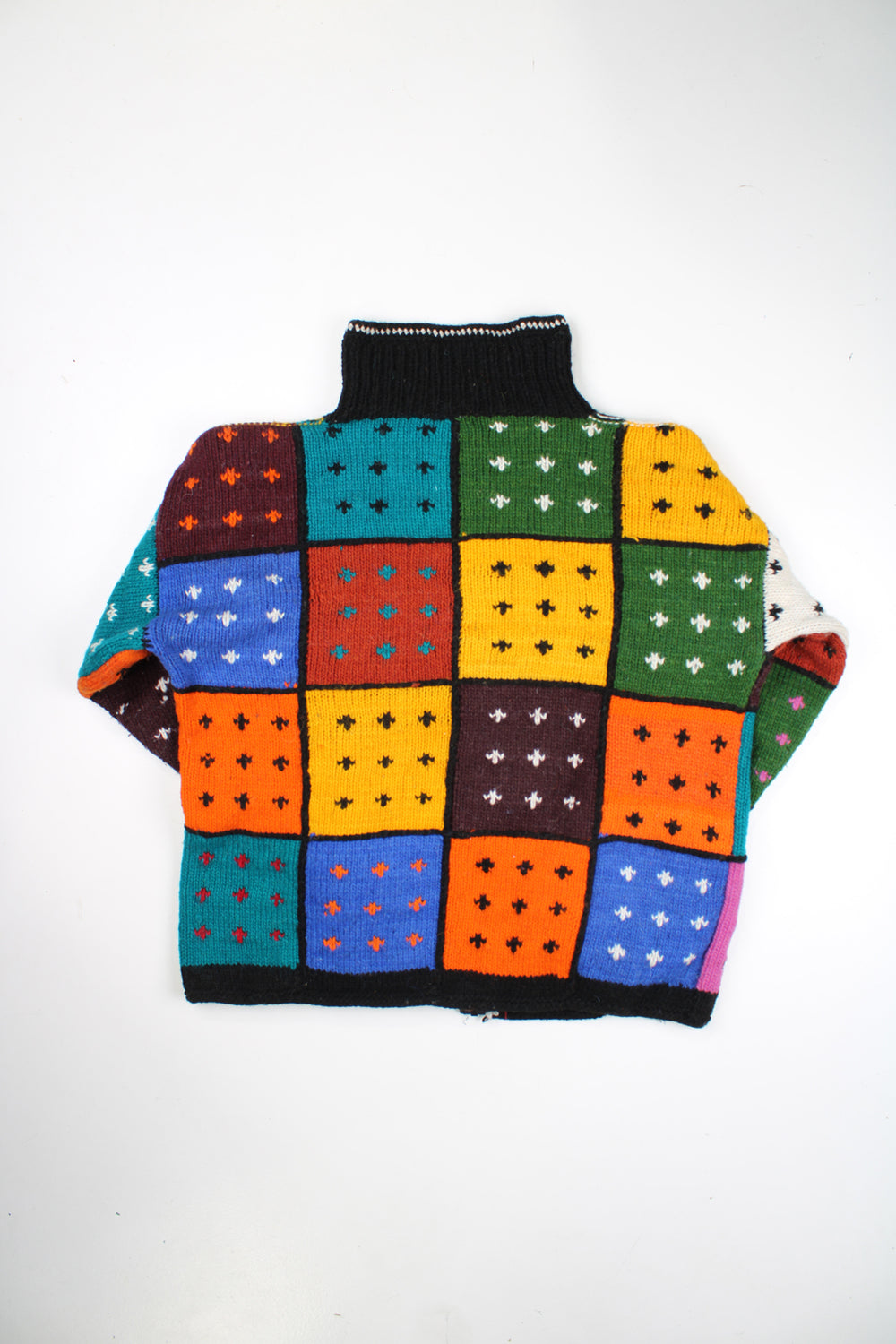 Vintage multicoloured knit cardigan with patchwork design. Made by Los Andes in Ecuador from 100% wool. Has two front pockets and closes with a full zip. good condition Size in Label: N/A- measures like an XL