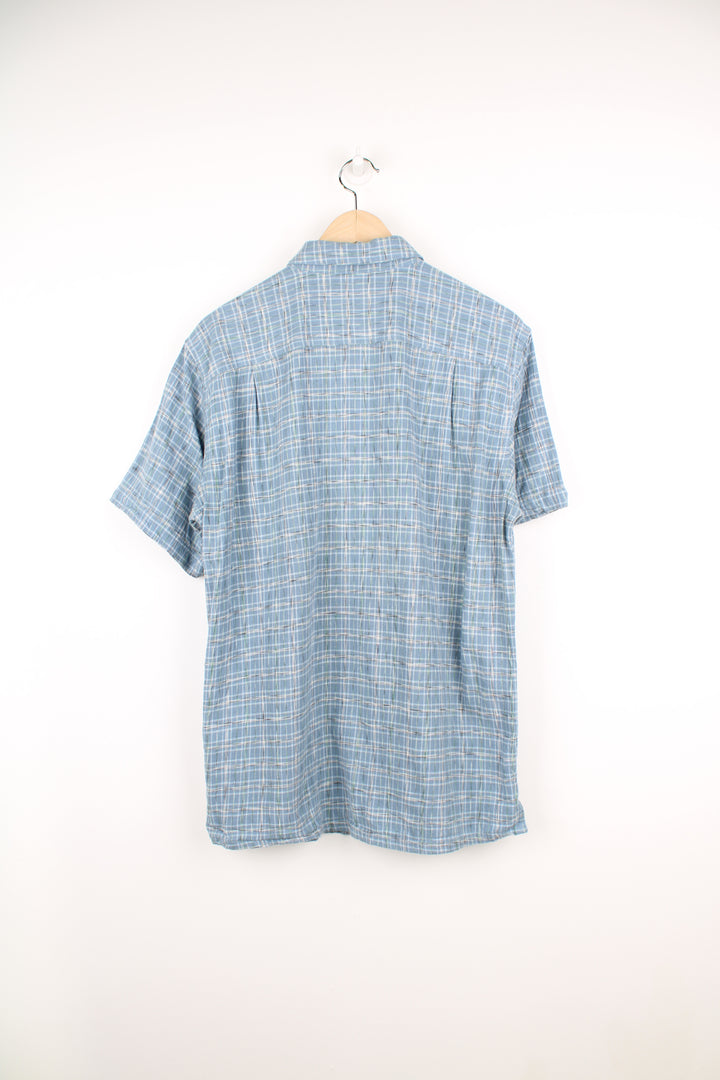 Patagonia Short Sleeve Plaid Shirt in a blue and white colourway, button up, double chest pockets and has the logo embroidered on the side.