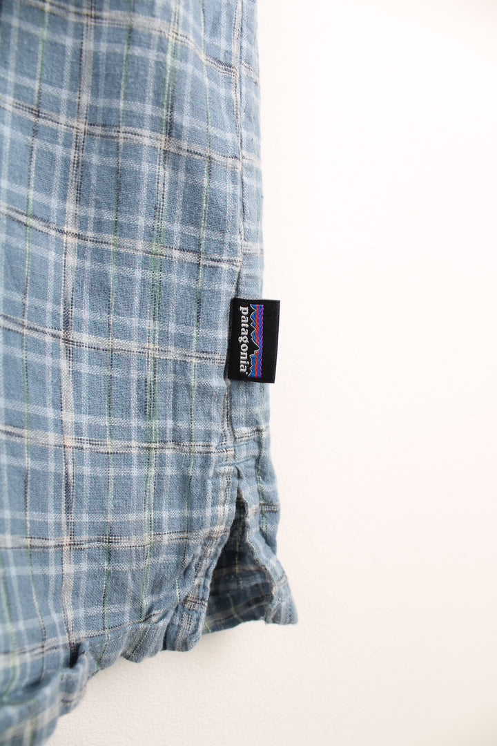 Patagonia Short Sleeve Plaid Shirt in a blue and white colourway, button up, double chest pockets and has the logo embroidered on the side.