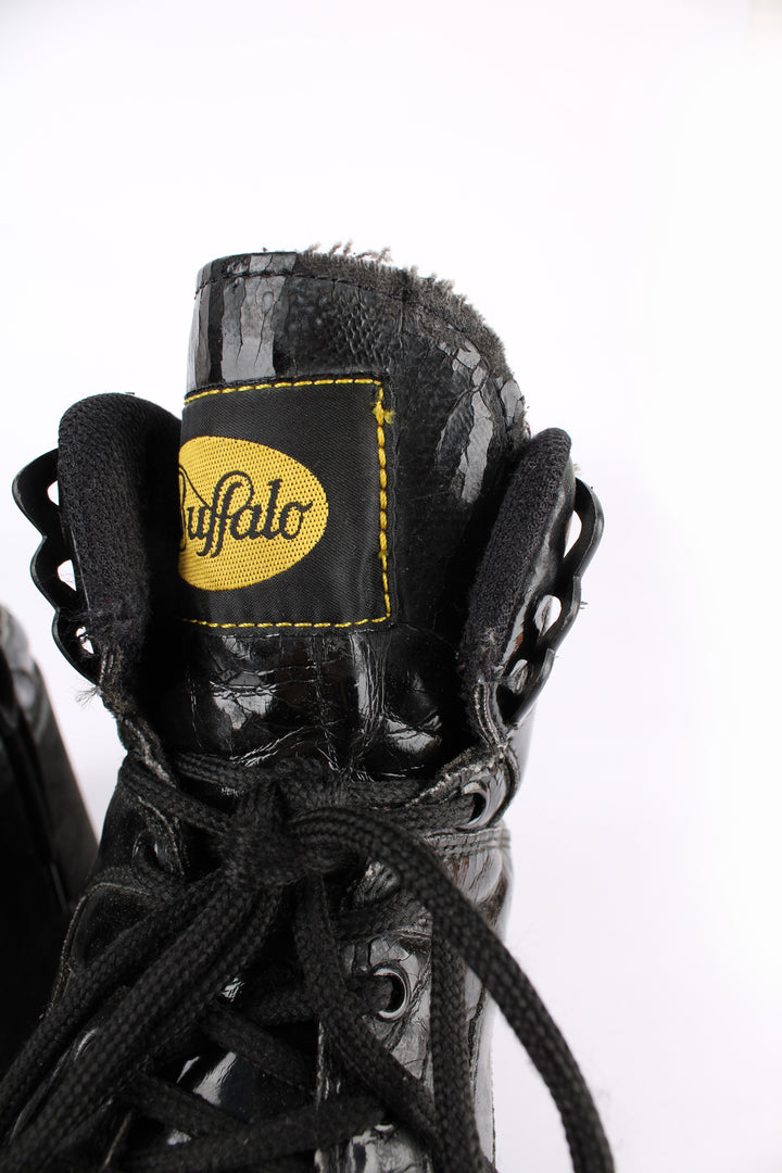 Buffalo Tower black patent leather platform lace up trainers, featuring buffalo branding on the back of the heel