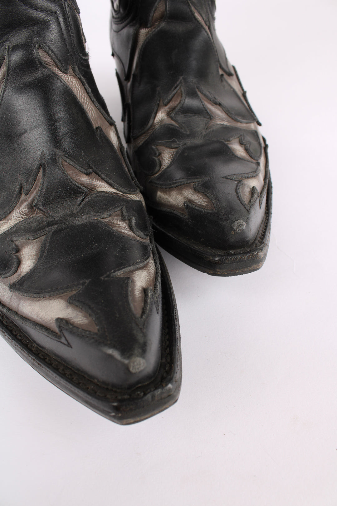 Vintage real leather black and grey cowboy boots features western cut out embroidery on the uppers