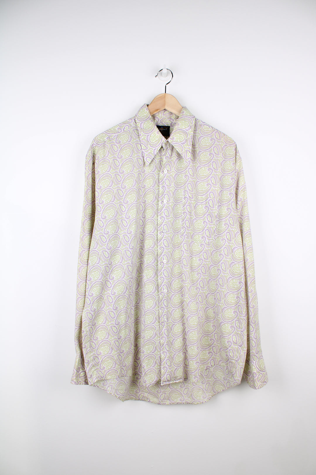 Vintage 70's long sleeve button up shirt in purple and lime green paisley pattern. Features a dagger collar. good condition Size in Label: XL 17/ 17 Measures like a mens XL