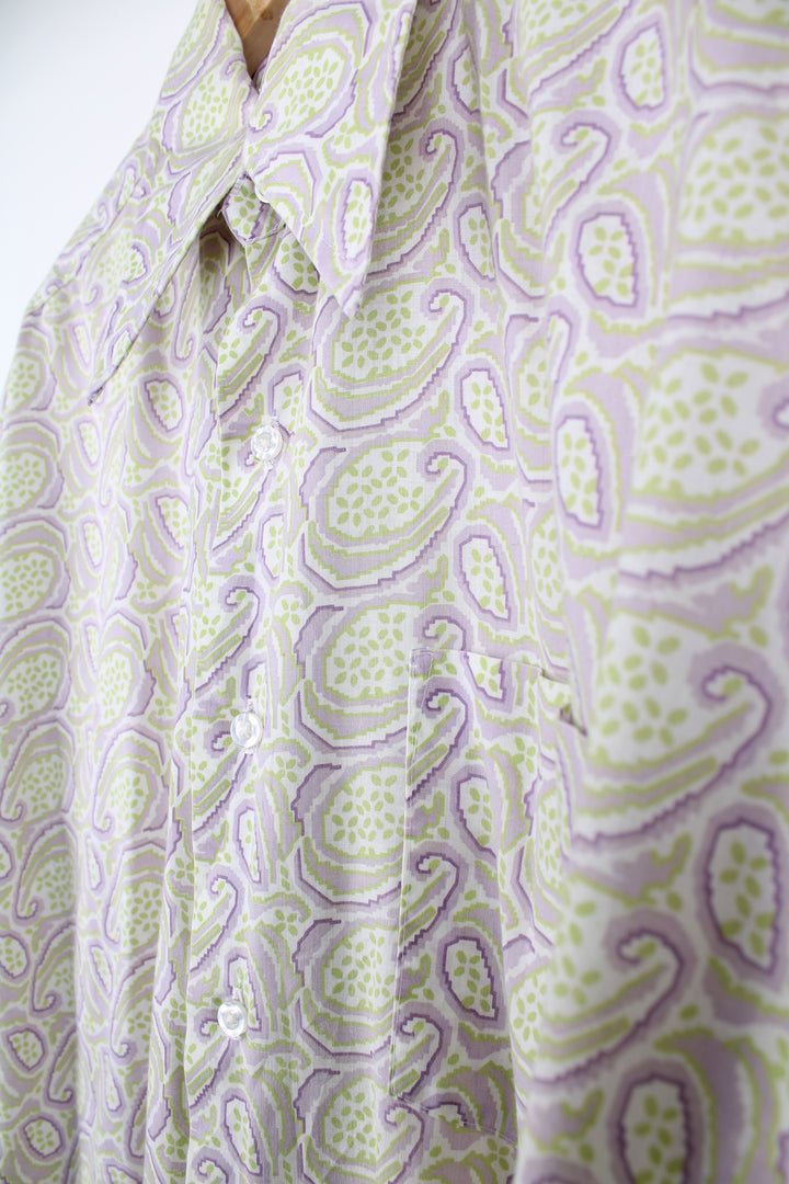 Vintage 70's long sleeve button up shirt in purple and lime green paisley pattern. Features a dagger collar. good condition Size in Label: XL 17/ 17 Measures like a mens XL