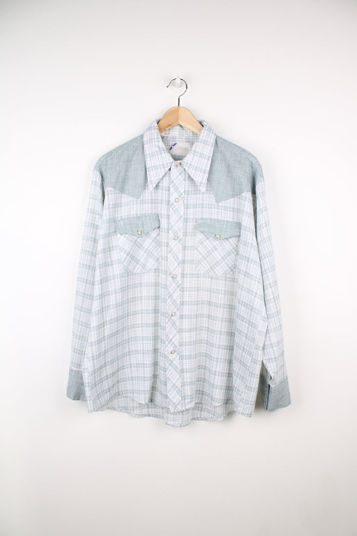 Vintage 70's long sleeve shirt in pale green check/ plaid pattern. Features western yoke detail on the front and back and a dagger collar. Closes with silver pearl snap buttons. good condition - A repair has been mare to the top of one of the pockets and the other has a faint stain. (see photos) Size in Label: Mens XL