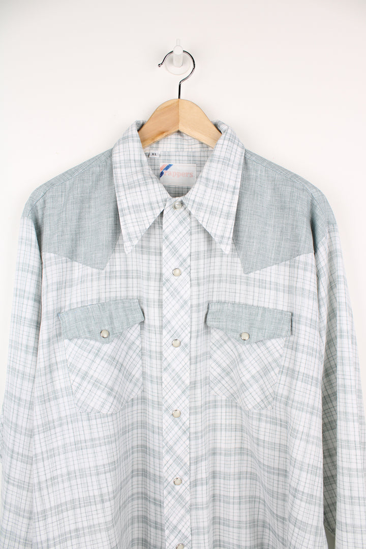 Vintage 70's long sleeve shirt in pale green check/ plaid pattern. Features western yoke detail on the front and back and a dagger collar. Closes with silver pearl snap buttons. good condition - A repair has been mare to the top of one of the pockets and the other has a faint stain. (see photos) Size in Label: Mens XL