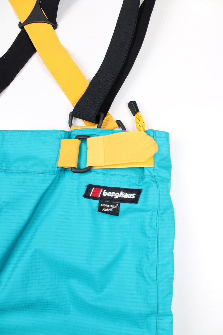 Vintage blue Berghaus Ski Salopettes. Slightly padded, elasticated waistband and adjustable shoulder straps. Closes with a zips and velcro at either side of the waistband.   good condition   Size in Label:  Womens size 16