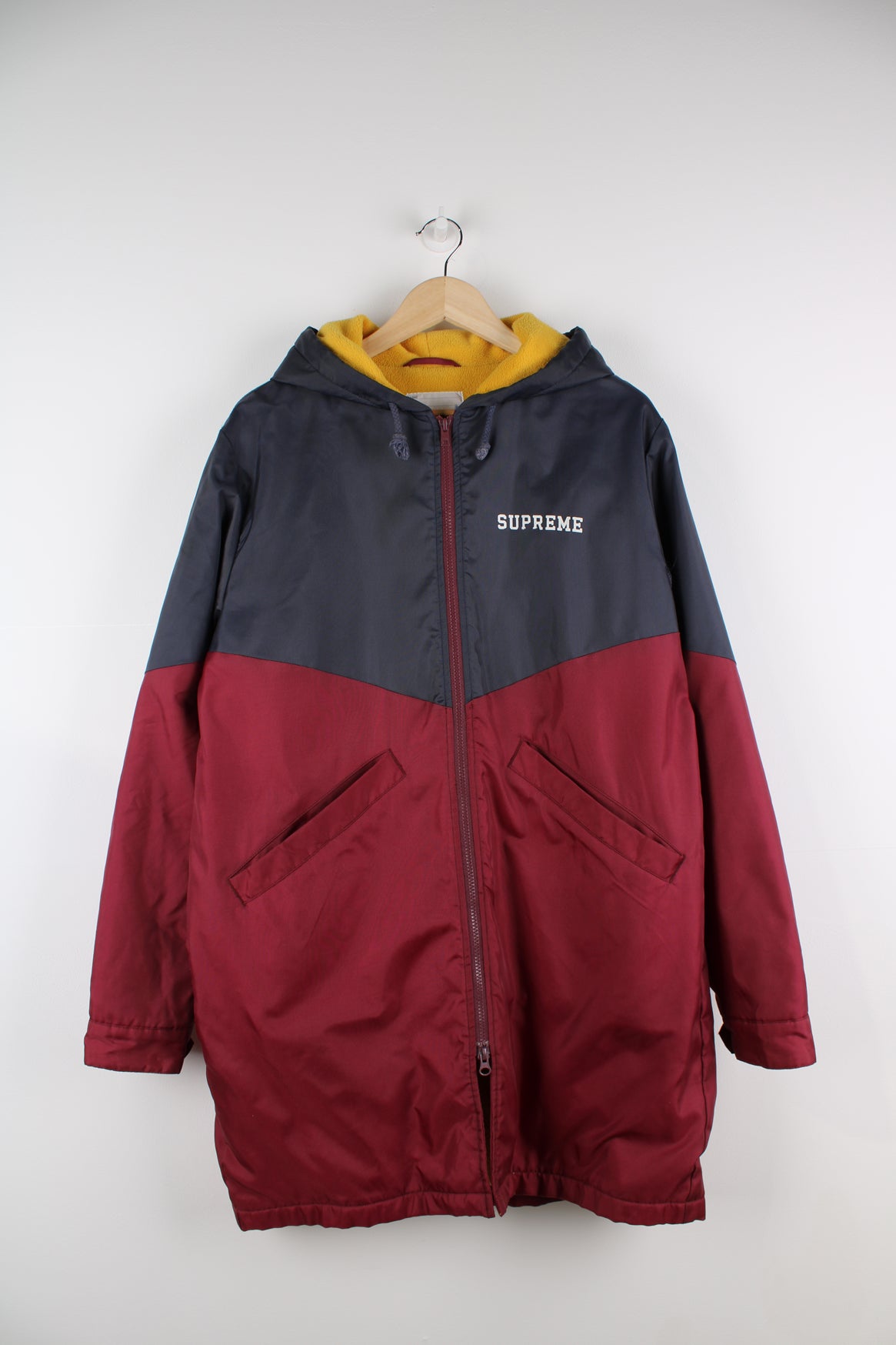 F/W 2012 Supreme Sideline Jacket. Fleece lined bench coat with full zip, hood and Supreme lettering printed on the front and back. good condition - a repair has been made to the seam under the armpit. A name has been written in the name tag. Size in Label: L