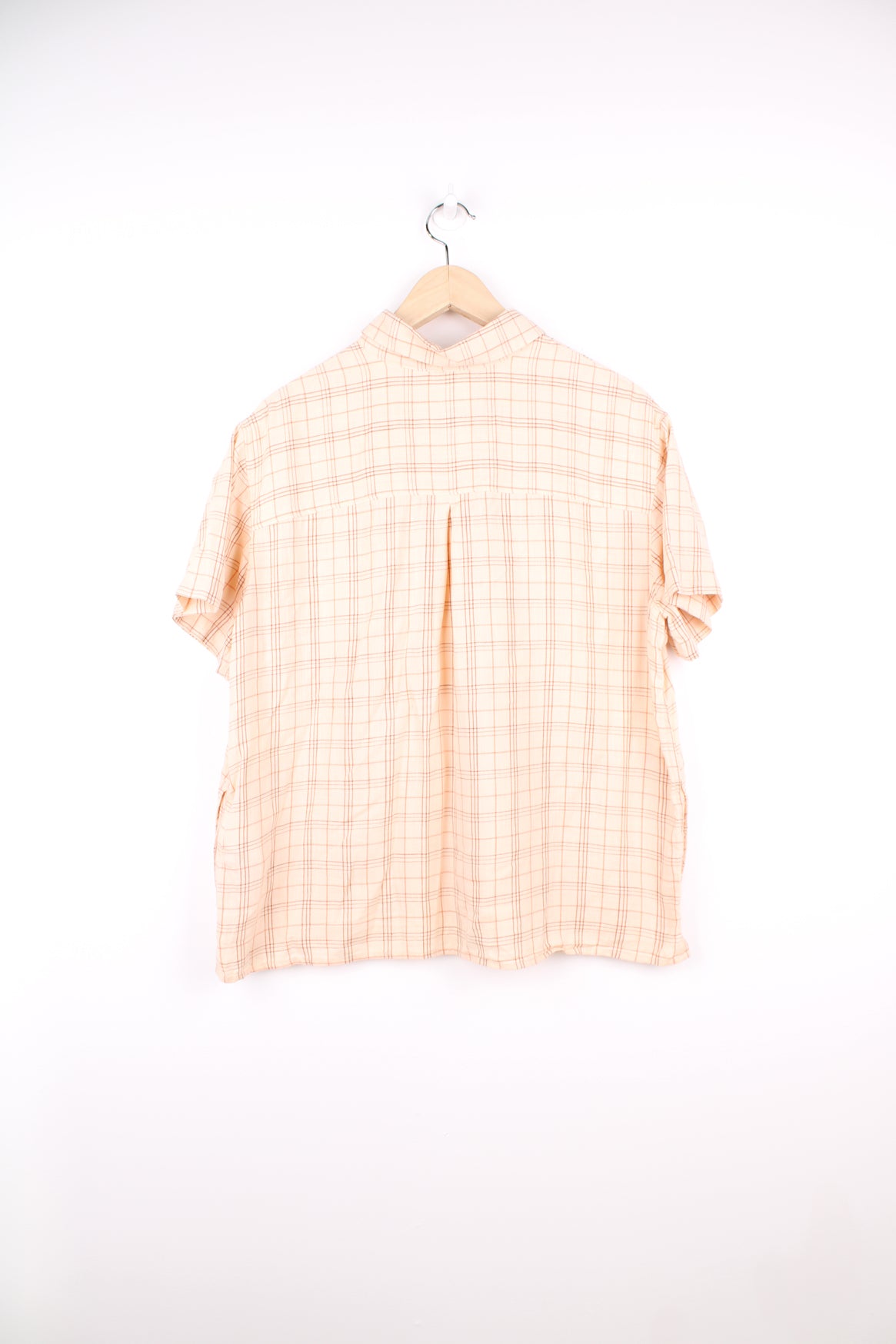 Carhartt Plaid Short Sleeve Shirt in a tan and red colourway, button up, cropped fit, has hidden side pockets, and also has the logo embroidered on the chest pocket.