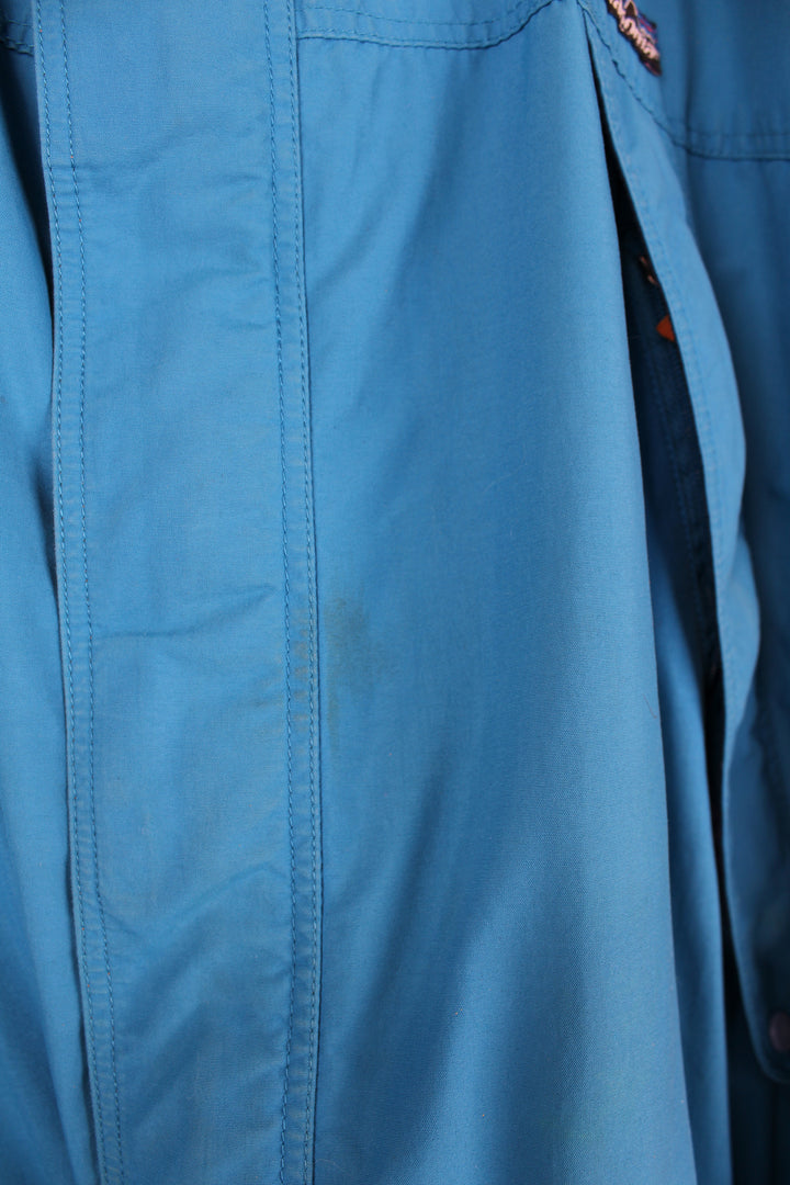 Patagonia Torrentshell outdoor jacket in blue, zip up, multiple pockets, hooded and has embroidered logo on the front.