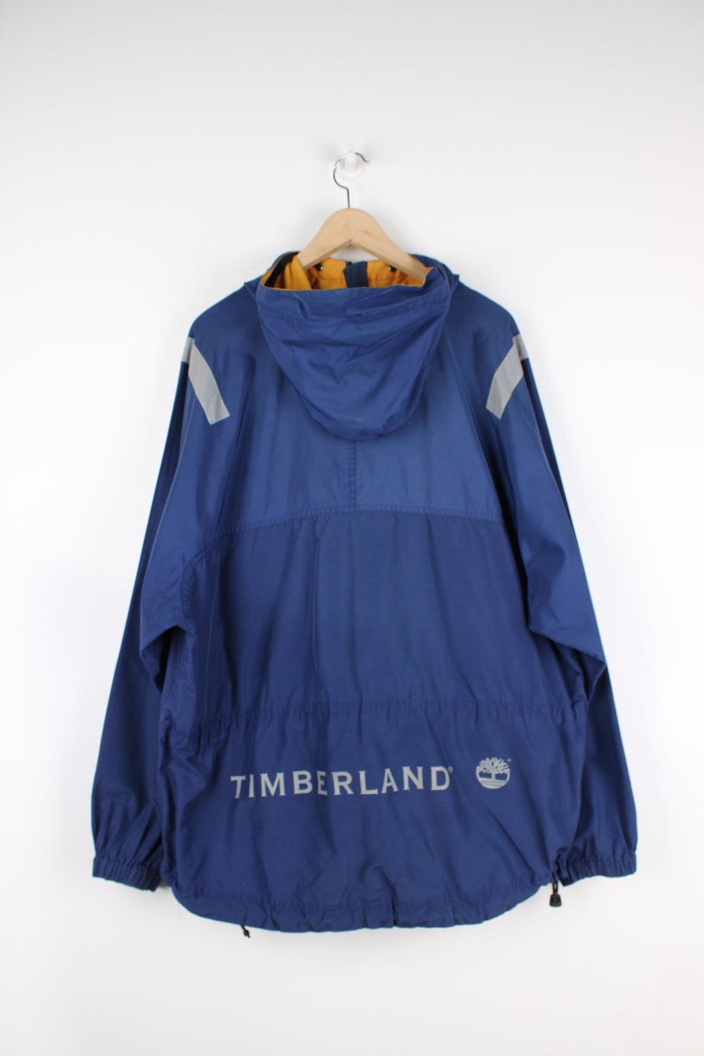 Vintage Timberland pullover jacket in blue, has 3m reflective stripes on the shoulders, multiple pockets, quarter zip up, and has logos embroidered on the front and back.