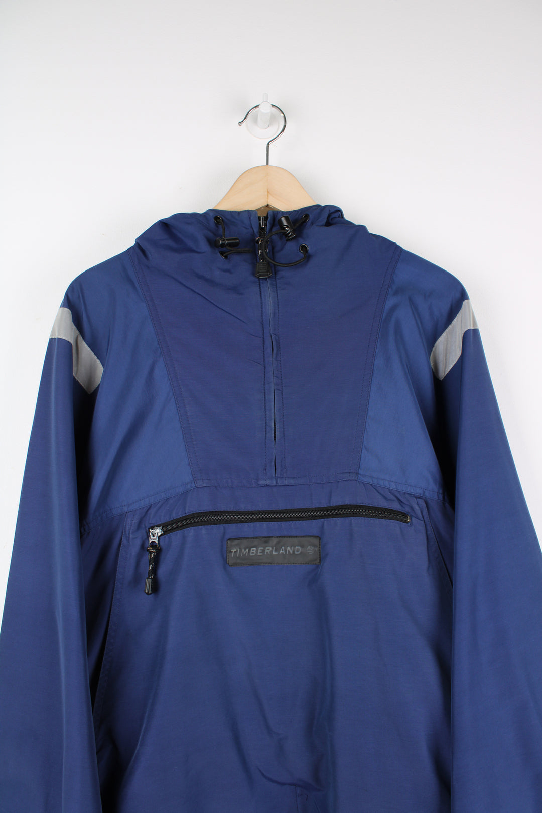 Vintage Timberland pullover jacket in blue, has 3m reflective stripes on the shoulders, multiple pockets, quarter zip up, and has logos embroidered on the front and back.