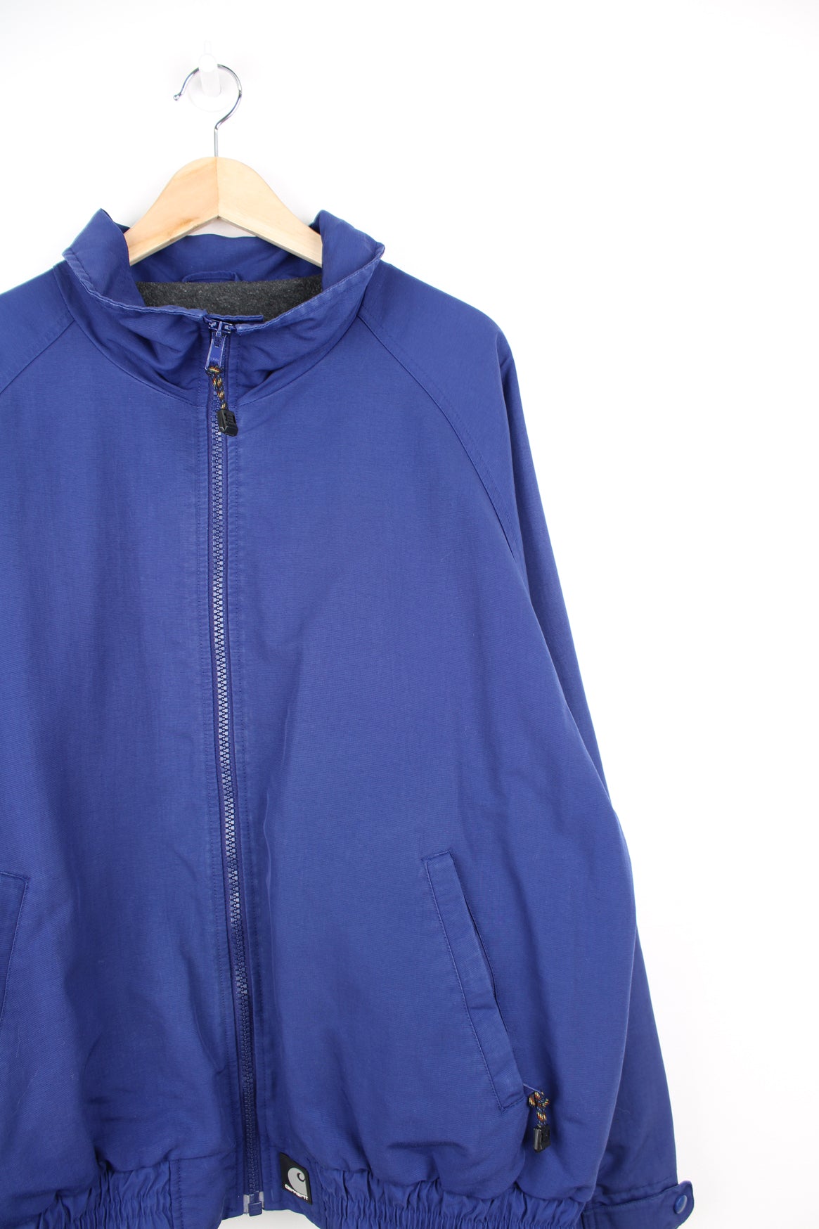 Carhartt Jacket in a blue colourway, zip up, fleece lining, side pockets and has the logo embroidered on the front.