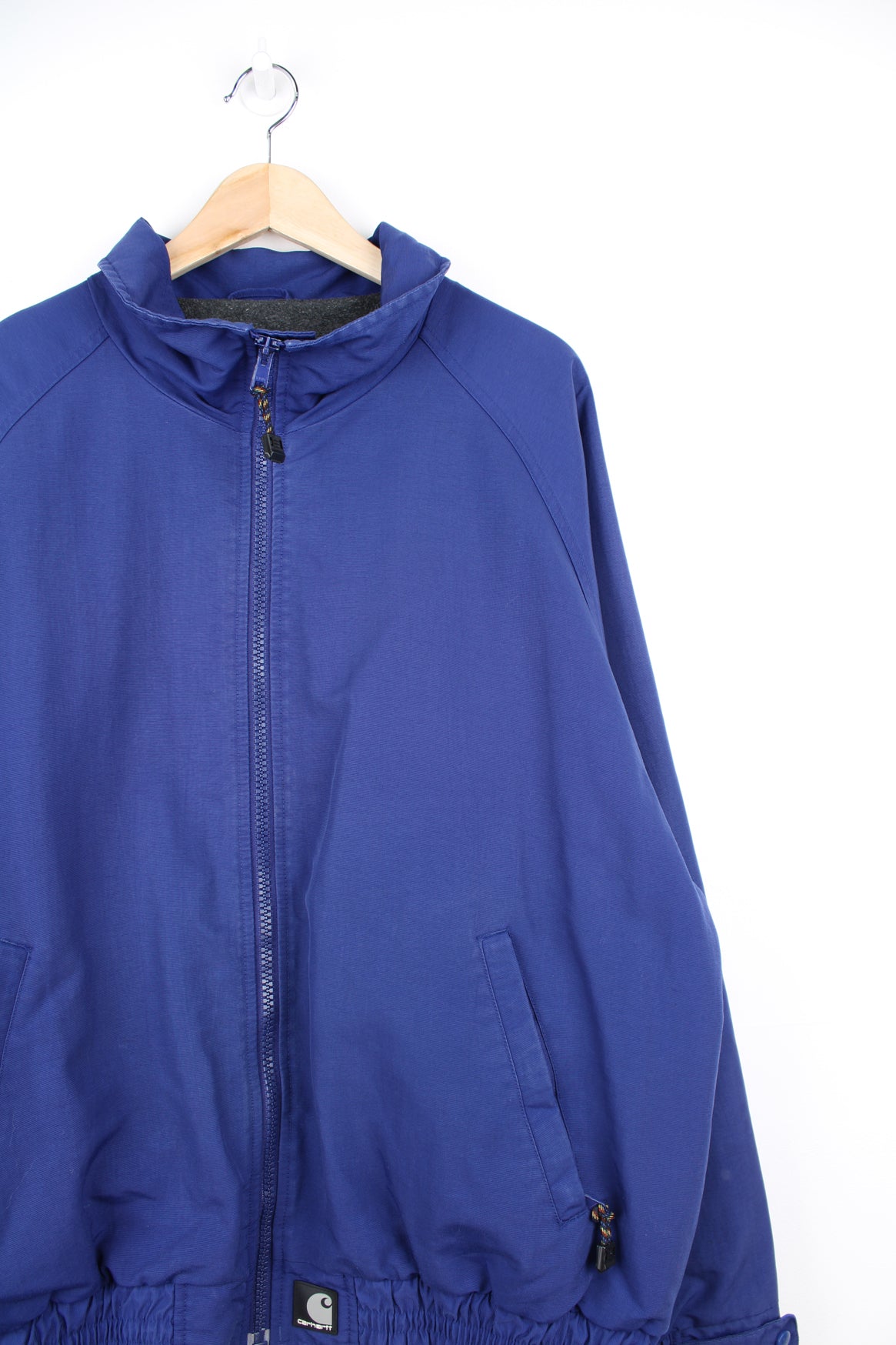 Carhartt Jacket in a blue colourway, zip up, fleece lining, side pockets and has the logo embroidered on the front.