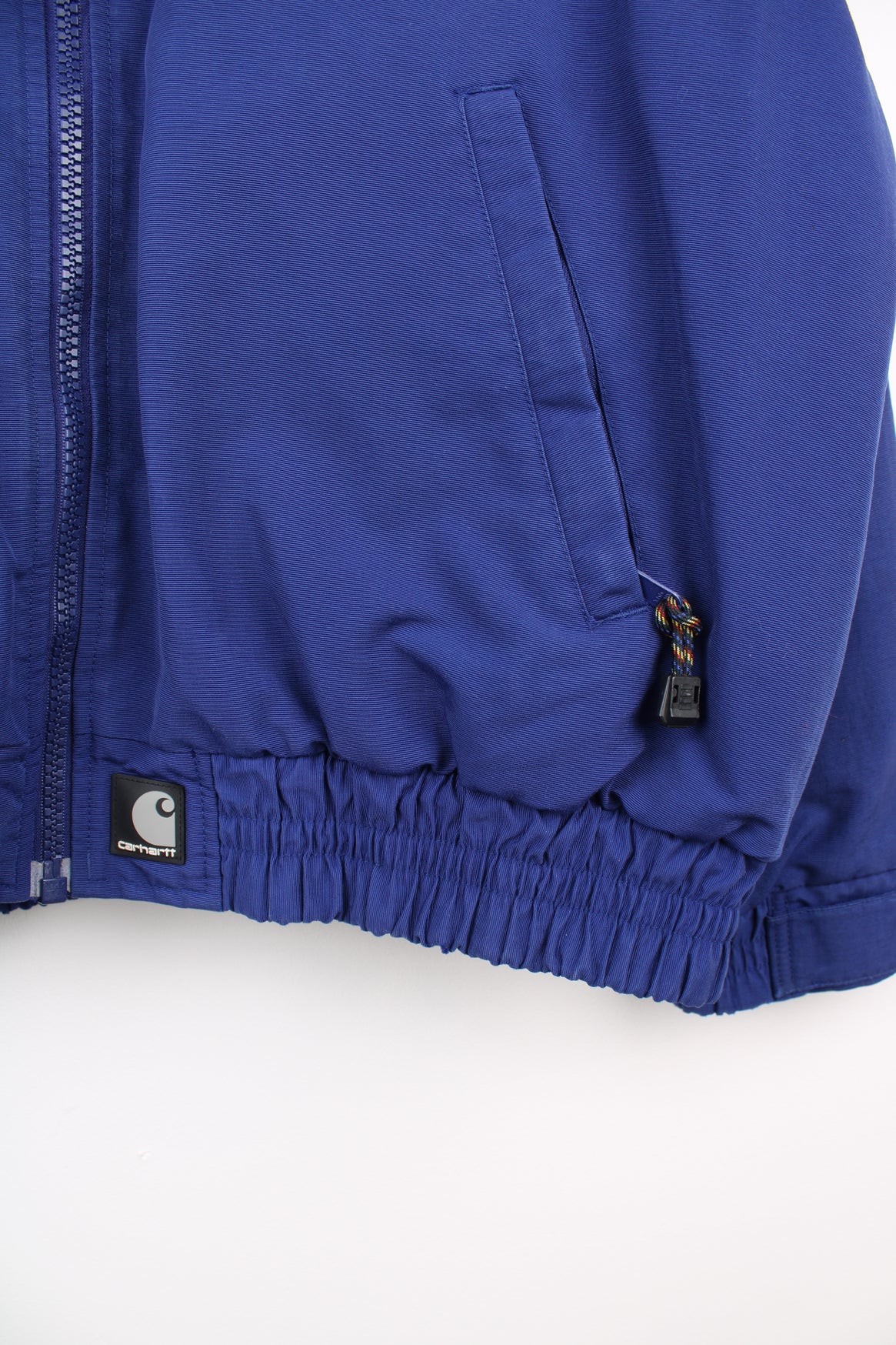 Carhartt Jacket in a blue colourway, zip up, fleece lining, side pockets and has the logo embroidered on the front.