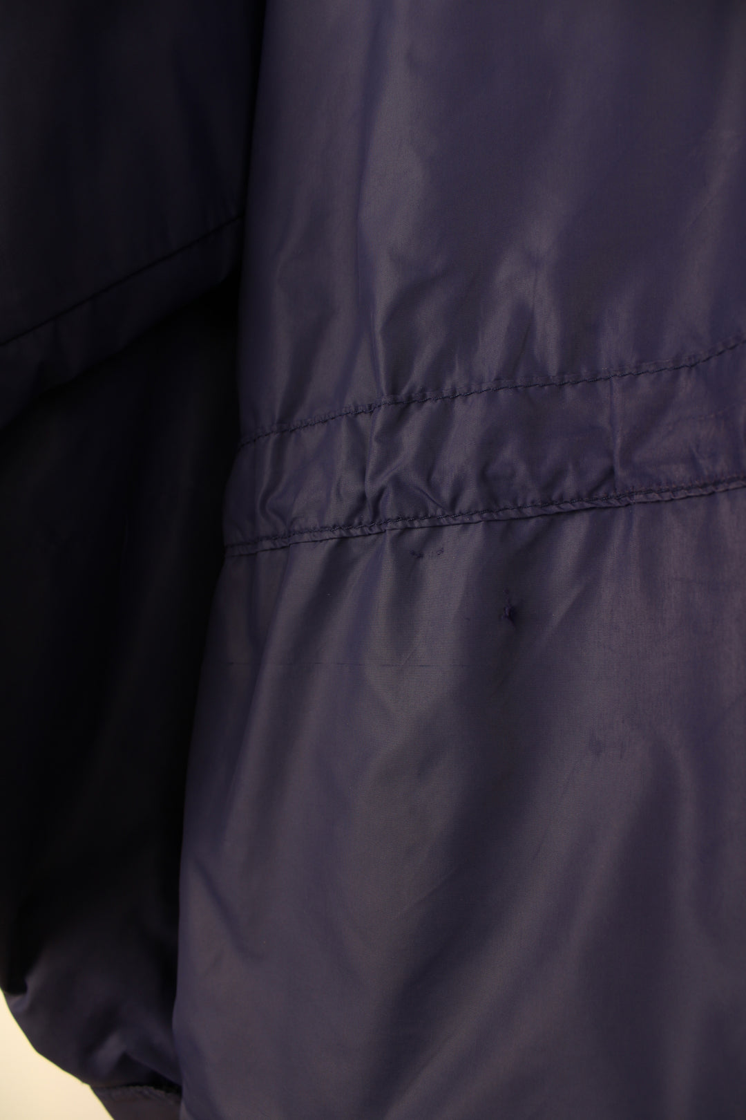 Vintage Rab Downpour waterproof jacket in purple, zip up, multiple pockets, hooded and has logo embroidered on the front.