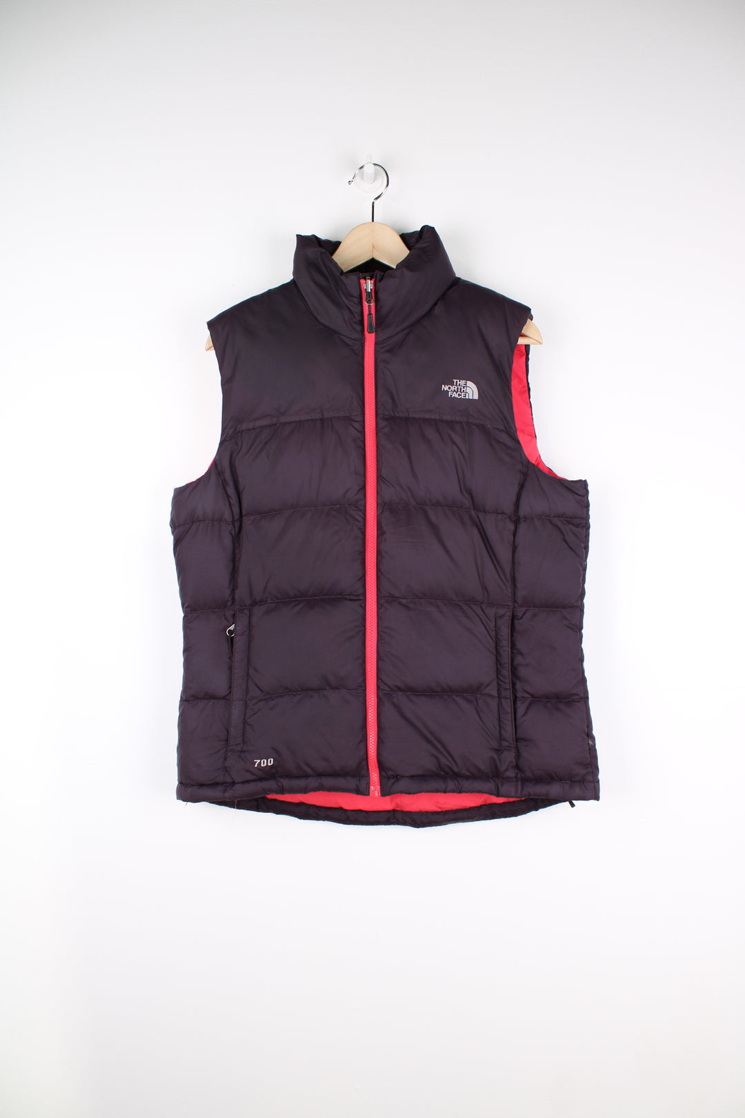 The North Face Gilet in a purple and pink colourway, zip up, insulated, and has logo embroidered on the front and back.