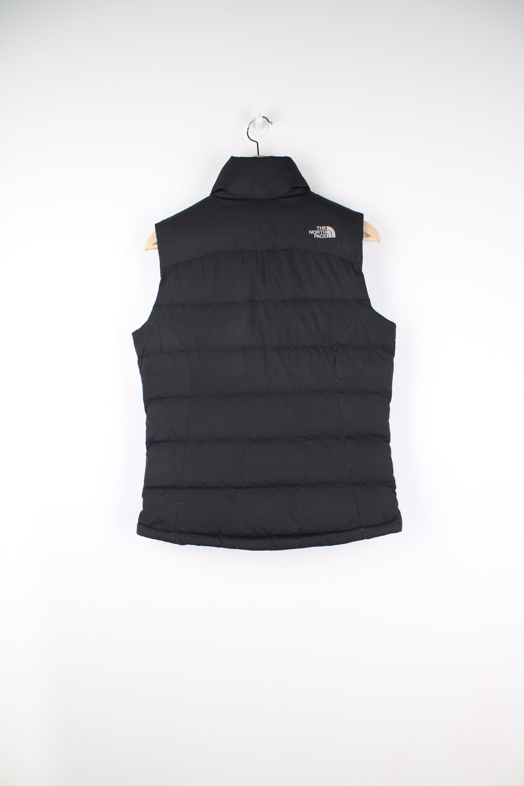 The North Face Face puffer gilet in black, zip up with side pockets, insulated and has logo embroidered logo on the front and back.